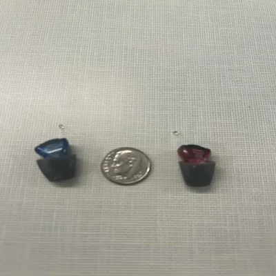 Audicus Mini CIC hearing aids compared in size to a dime