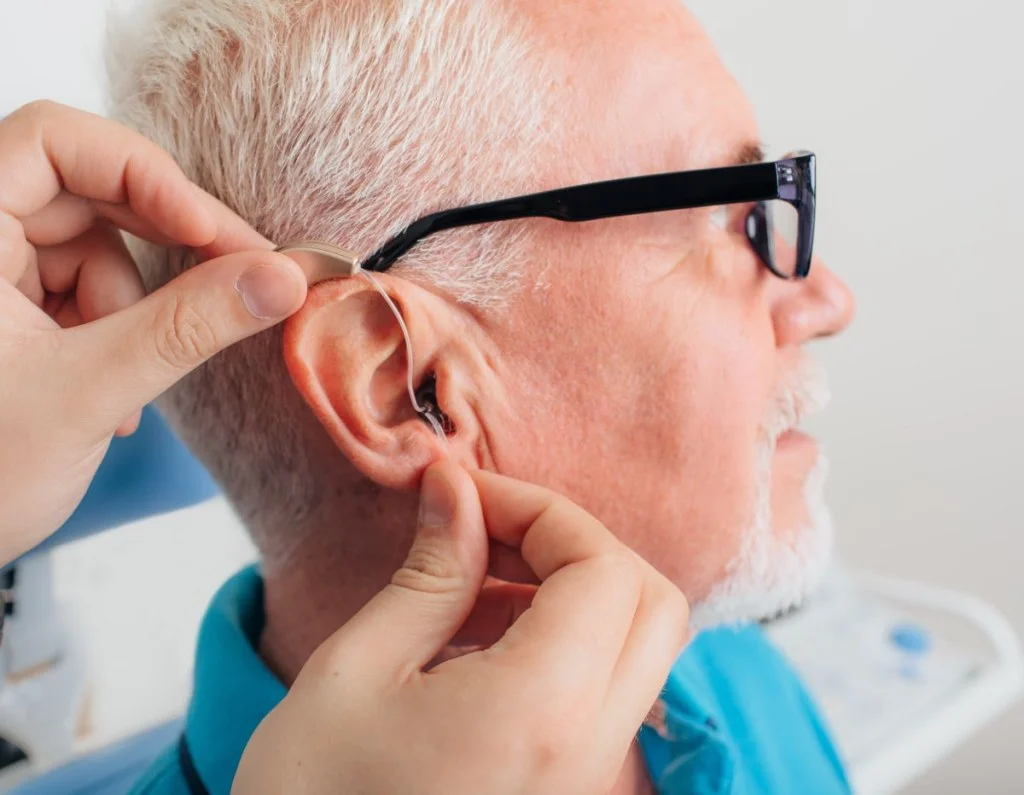 A man being fitted for hearing aids
