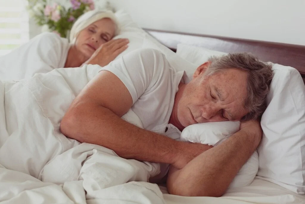 side view of active senior caucasian couple sleeping