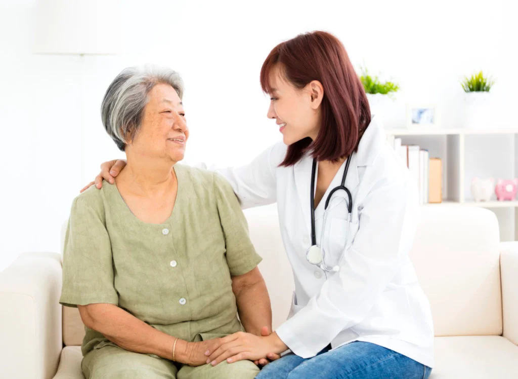 young smiling home caregiver with senior woman