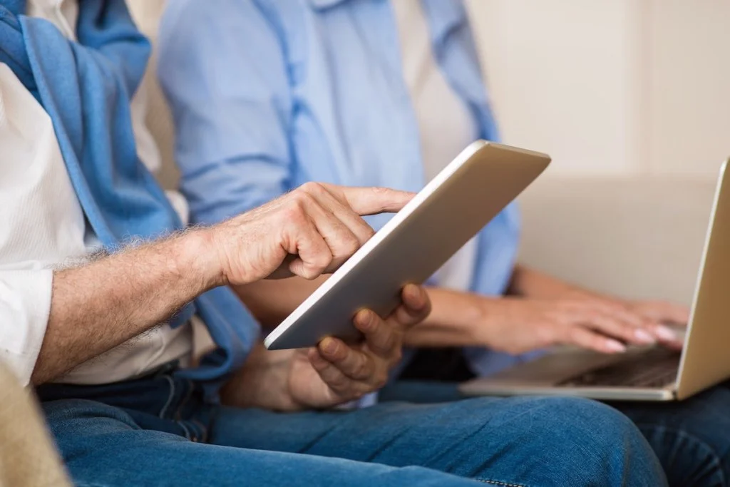 modern grandparents senior couple using gadgets