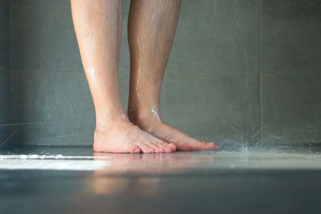 person standing in wet shower