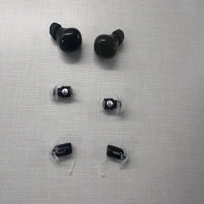 Eargo Link, Eargo SE, and Eargo 7 hearing aids sitting on a counter in a row.
