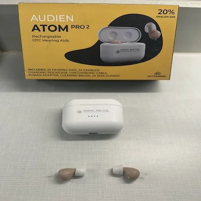 The Audien Atom Pro 2 with its charging case and outer packaging