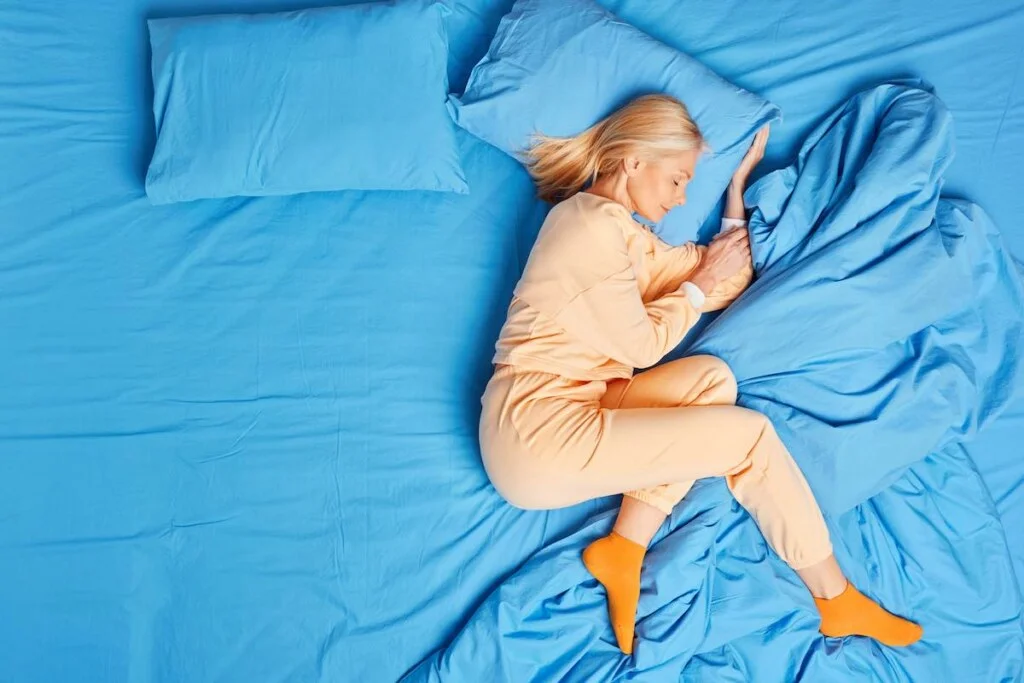 beautiful blonde senior woman lying on one side