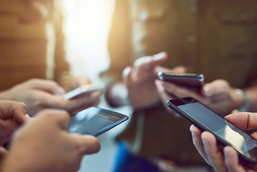 group of colleagues using their smart phones