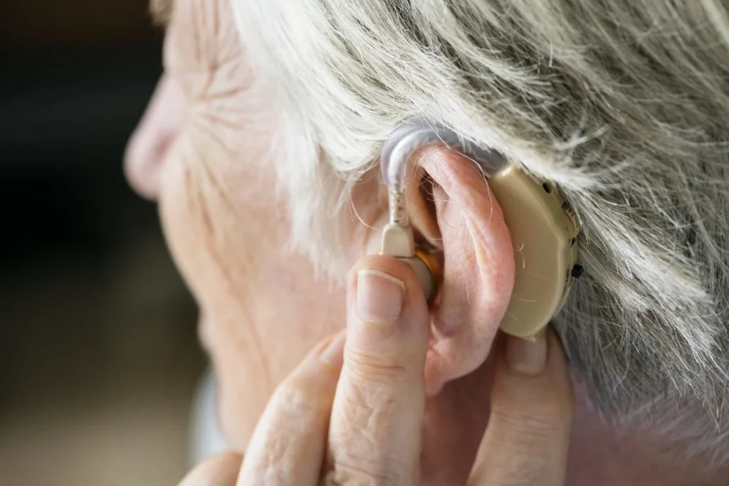 elderly woman wearing a hearing-aid