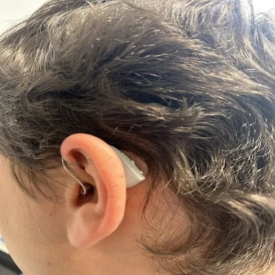 Lexie’s B2 Plus hearing aid in a man’s ear