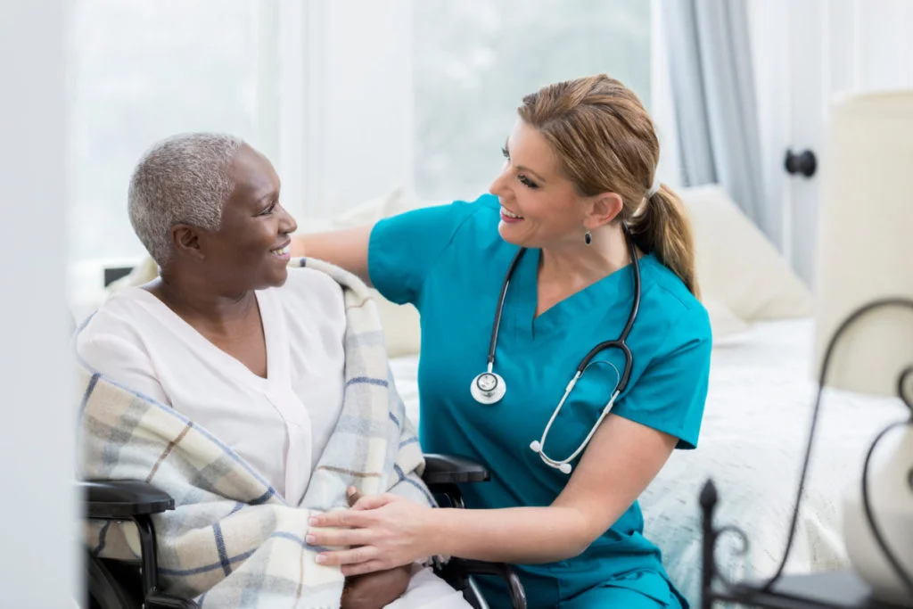 Nurse taking care of a patient in the patient's home.