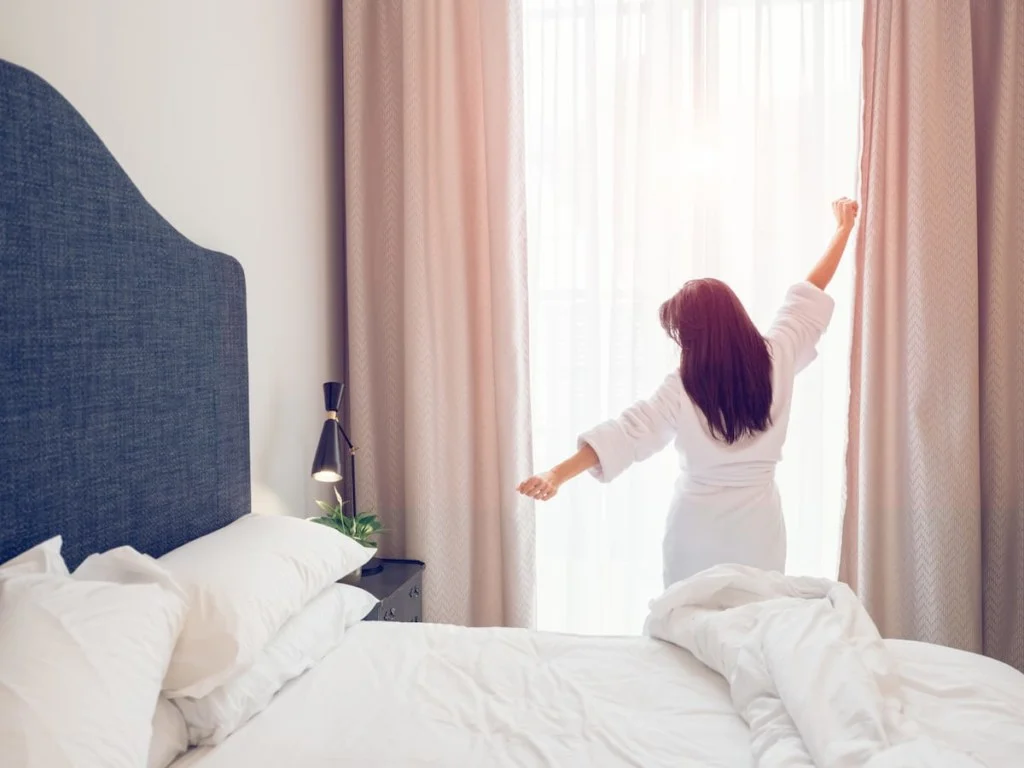 woman stretching in bedroom